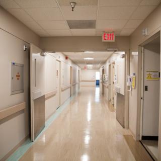 A quiet hospital corridor with clean, well-lit surroundings.