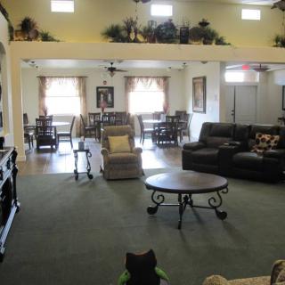 A spacious living room with sofas, tables, and decorative elements.