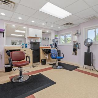 A cozy hair salon with multiple chairs and styling stations.