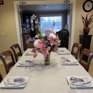 A beautifully arranged dining table with floral centerpiece and elegant tableware.