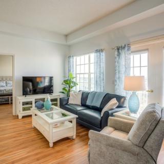 A cozy living room with a sofa, TV, and stylish decor.