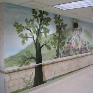A beautifully painted mural depicting trees and a natural landscape, enhancing the interior hallway.