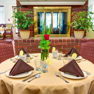 Elegant restaurant table setting with neatly arranged napkins and a floral centerpiece.