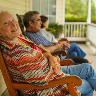 A joyful moment on the porch, where generations come together to enjoy the simple pleasures of life.
