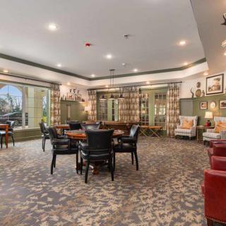 A spacious and elegantly decorated lounge with multiple seating areas and ambient lighting.