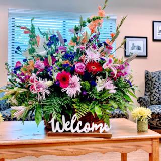 A vibrant floral arrangement welcomes guests in a cozy setting.