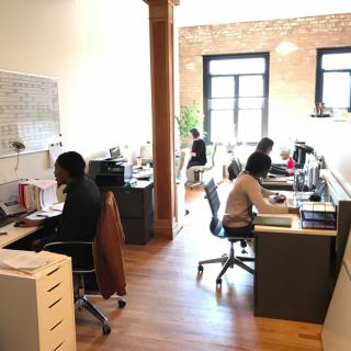 An open-plan office with people working at their desks.