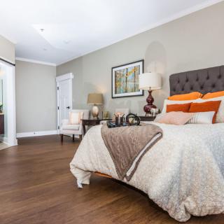 A modern and cozy bedroom with stylish furnishings and warm tones.