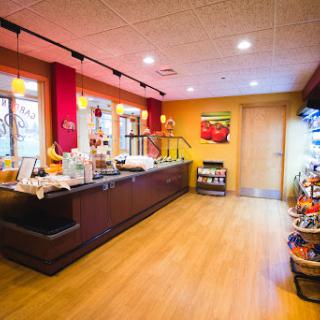 A vibrant and welcoming cafe interior featuring a food bar and bright decor.