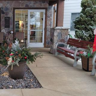 A welcoming entrance with holiday decorations and seating area.