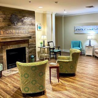 A cozy living room with a fireplace and comfortable seating arrangements.