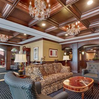 Luxurious hotel lobby with elegant chandeliers and classic furniture.