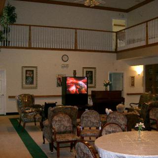 A spacious two-story living room with comfortable seating and a television.