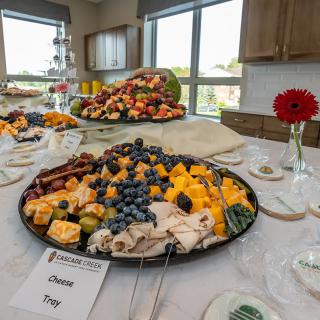 A beautifully arranged buffet table featuring a cheese and fruit platter, perfect for a party or catered event.