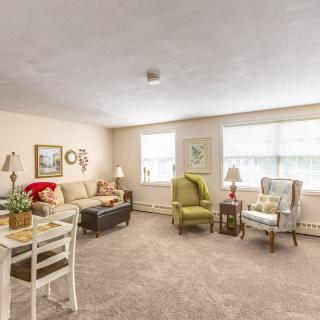 A cozy and well-lit living room with comfortable furniture and tasteful decor.
