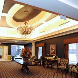 An elegantly designed lobby featuring a beautiful chandelier, luxurious seating, and tasteful decor.