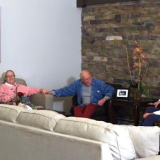 A serene moment in a living room where people are engaged in conversation.