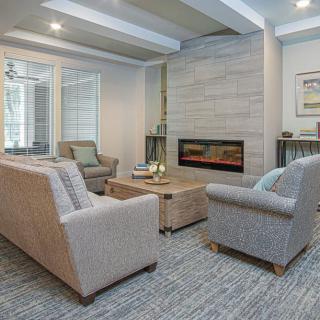A modern living room with comfortable seating and a stylish fireplace.