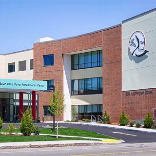 A modern hospital building with a brick and glass facade.