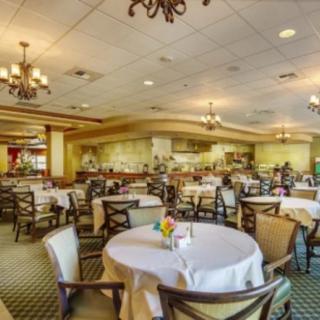 An elegant restaurant interior with neatly arranged tables and chandeliers.