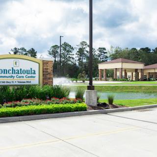 Welcome to Homechaloula Community Care Center, a serene healthcare facility surrounded by lush landscaping.