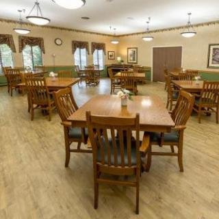 A spacious and inviting dining room with wooden tables and chairs, designed for communal meals.