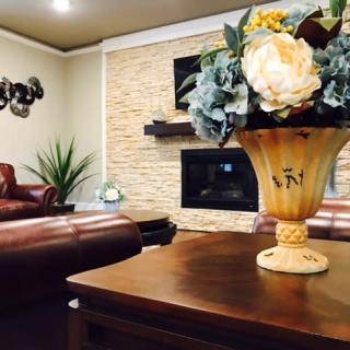A cozy living room with a stylish floral arrangement and modern fireplace.