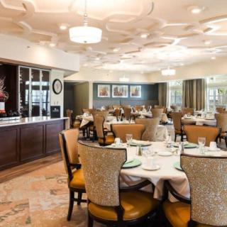 An elegant dining room with neatly arranged tables and chairs, ready for guests.