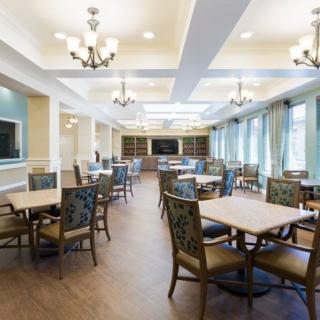 A spacious and well-lit dining area with multiple tables and chairs.