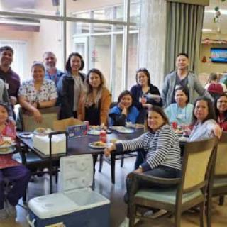 A joyful gathering of friends sharing a meal together in a warm, inviting space.