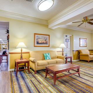 A cozy living room with comfortable seating and warm lighting.