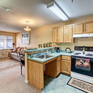 A cozy apartment with an open kitchen leading into a comfortable living room area.