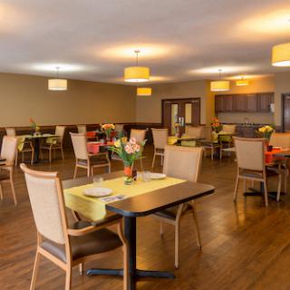 A cozy dining area with elegant decor and well-arranged tables, perfect for enjoying a meal.
