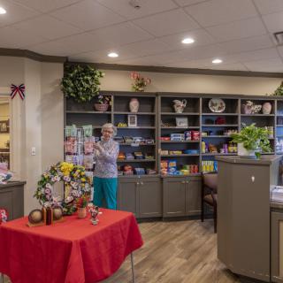 A cozy gift shop filled with various items and books on display.