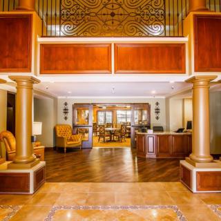 Spacious hotel lobby with elegant wooden decor and a welcoming reception area.