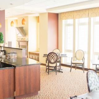 A sunlit lounge area with elegant furniture and large windows.