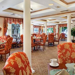 Elegant dining area with patterned chairs and neatly arranged tables.