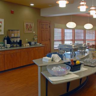 A cozy cafe interior featuring a central counter and coffee station.