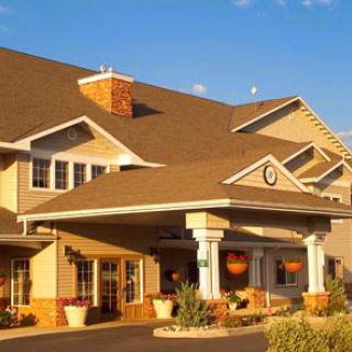 A charming hotel with a welcoming entrance, set against a serene sunset.