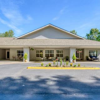 Exterior view of a building with a welcoming entrance and landscaped surroundings.