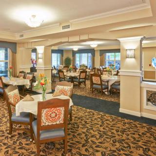 Elegant dining room with neatly arranged tables and comfortable seating.