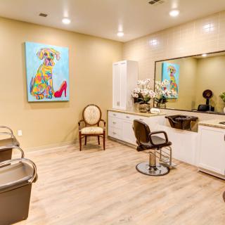 A modern salon interior with stylish decor and colorful artwork.
