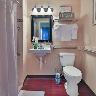 A modern bathroom with a sink, toilet, and shower.