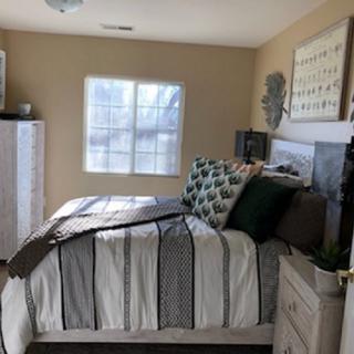A cozy bedroom with stylish decor and natural light.