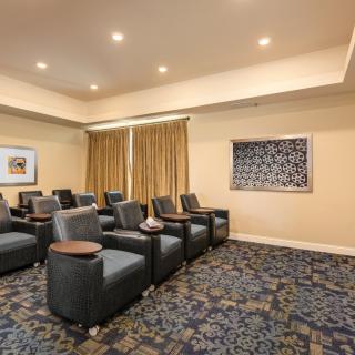 A cozy indoor theater room with recliner seating and ambient lighting.