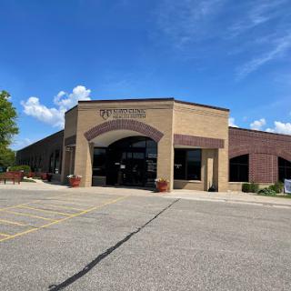 A modern commercial building with a welcoming entrance on a sunny day.