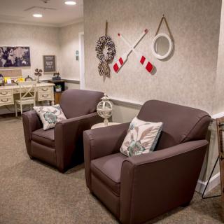 A cozy waiting room with comfortable armchairs and stylish wall decor.