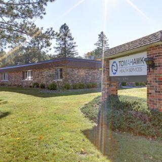A view of an office building with clear signage and well-maintained landscaping.