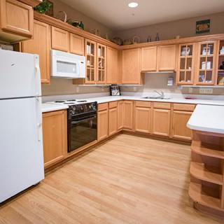 A spacious kitchen with wooden cabinets and modern appliances.