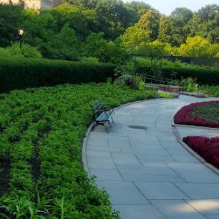 A serene pathway winding through a beautifully landscaped garden, inviting visitors to relax and enjoy nature.